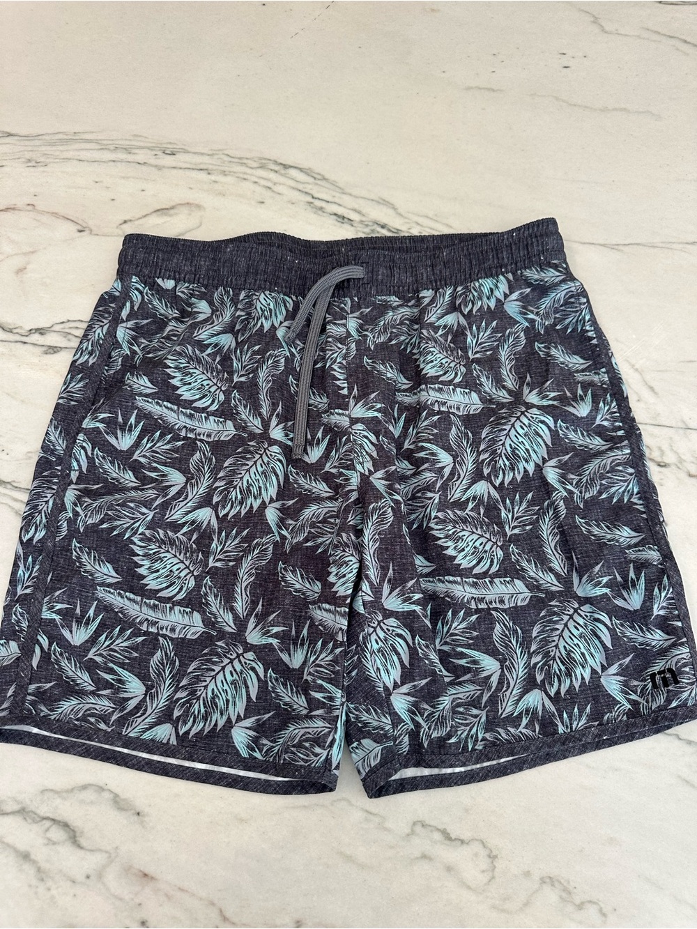 Travis Mathew Navy Swim Trunks with Tropical Print. Drawstring, unlined. M
